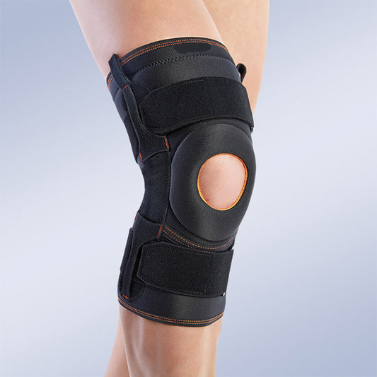 Windowed knee brace with patellar centering and lateral stabilizers