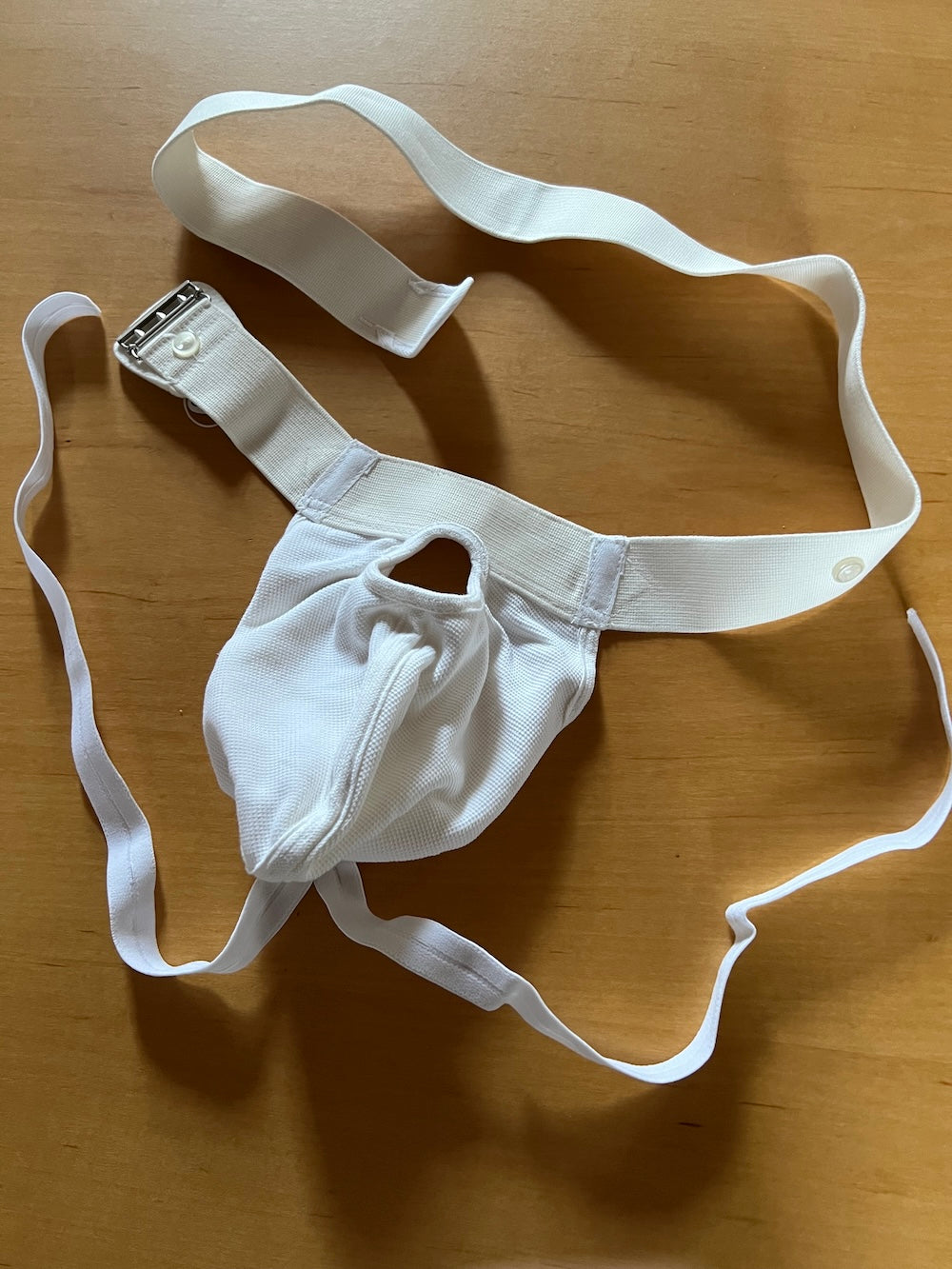 Lux testicular suspender with penis passage